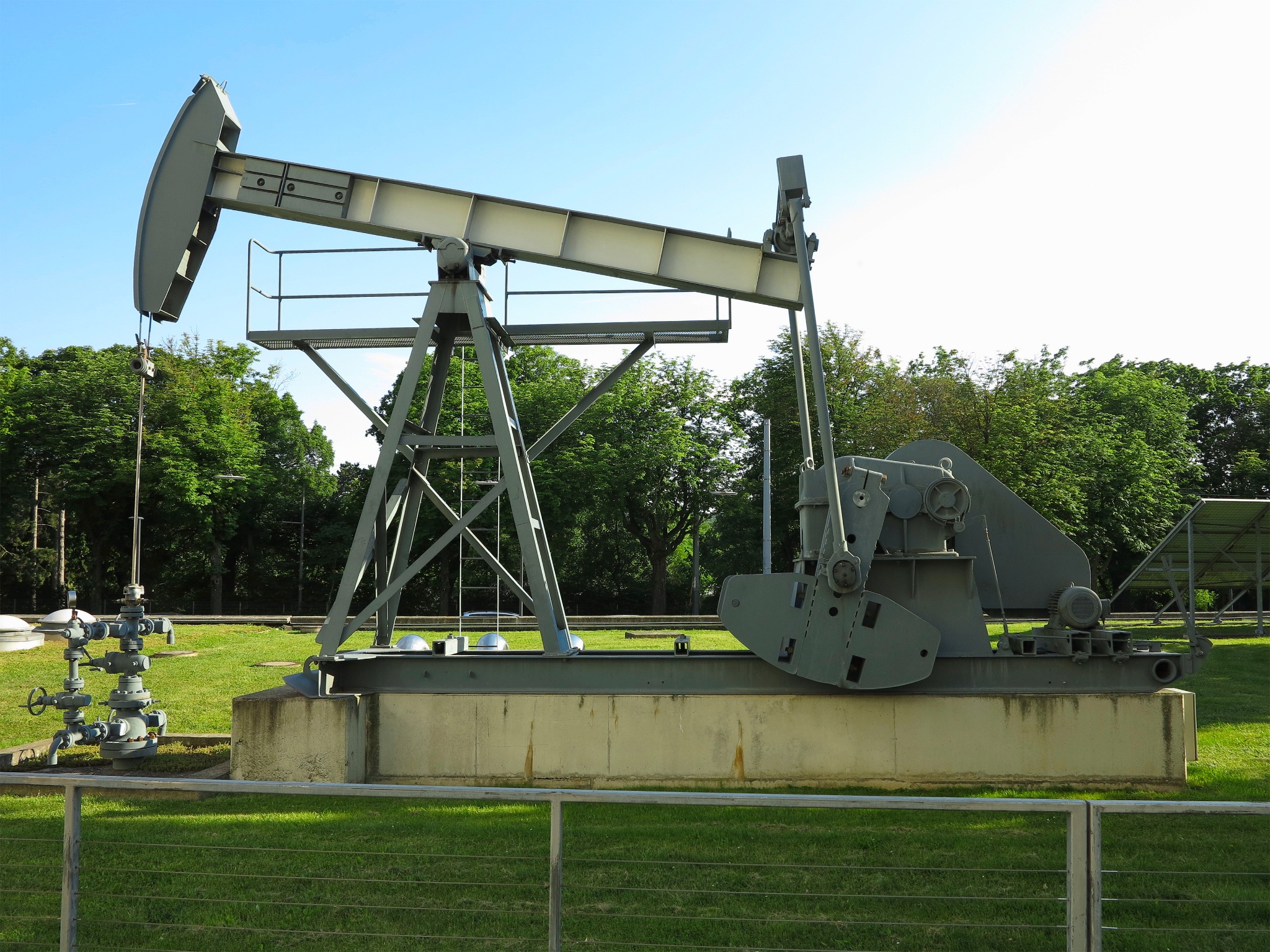 Oilfield drilling image with pumpjack and wellhead equipment